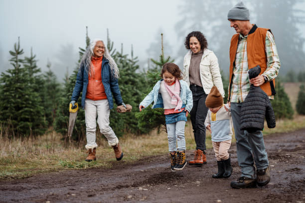 istock Happy multi-generation family walking along dirt path at Christmas tree farm 2193180167