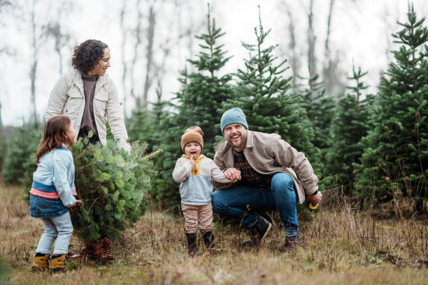 istock Joyful family choosing a Christmas tree 2193180169