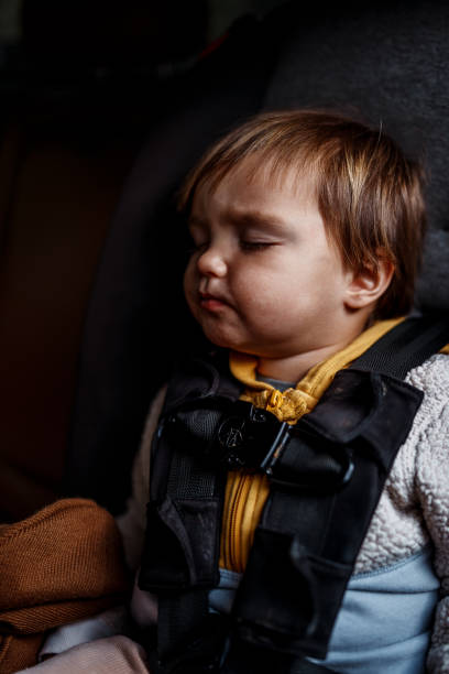 istock Sleeping toddler boy in car safety seat 2193180181