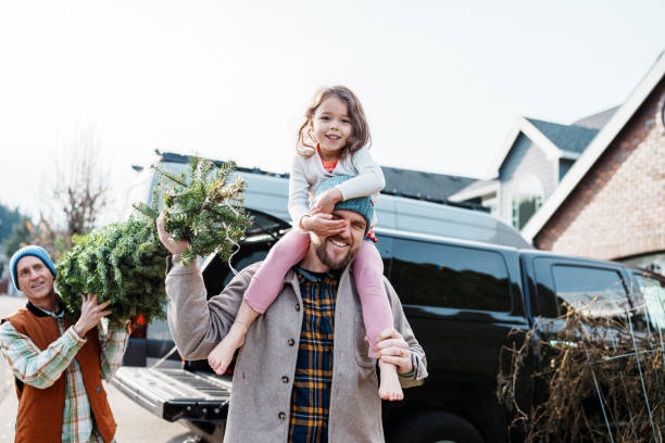 istock Multi-generation family bringing a Christmas tree home 2193180191
