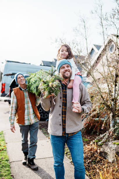 istock Happy multi-generation family bringing a Christmas tree home 2193180193
