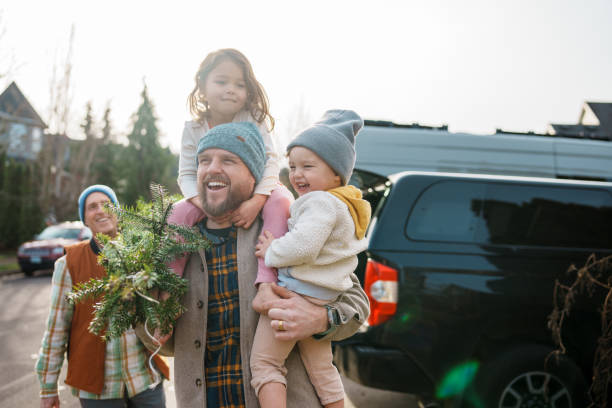 Loving dad and his kids bringing a Christmas tree home