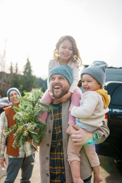 istock Loving dad and his kids bringing a Christmas tree home 2193180197