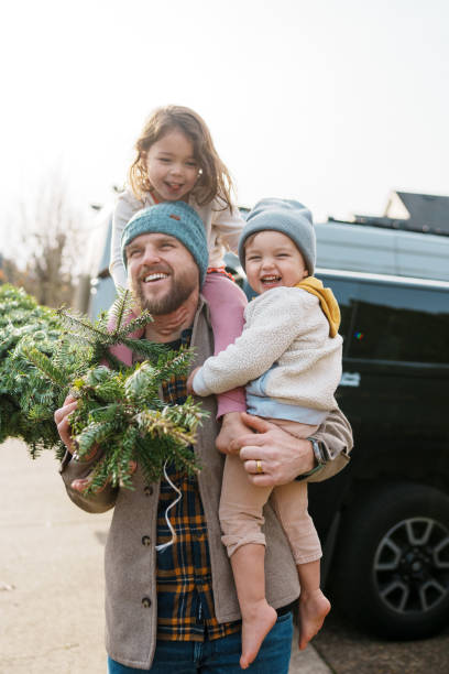 istock Loving dad and his kids bringing a Christmas tree home 2193180198