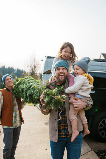 istock Joyful multi-generation family bringing a Christmas tree home 2193180202