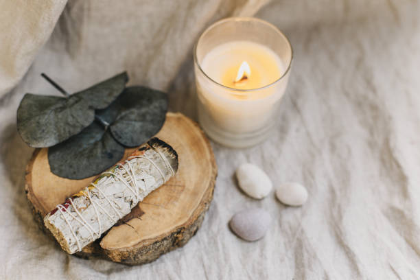 istock White sage and candle with stones for meditation. Minimalism. Calm and mindfulness. 2193186908