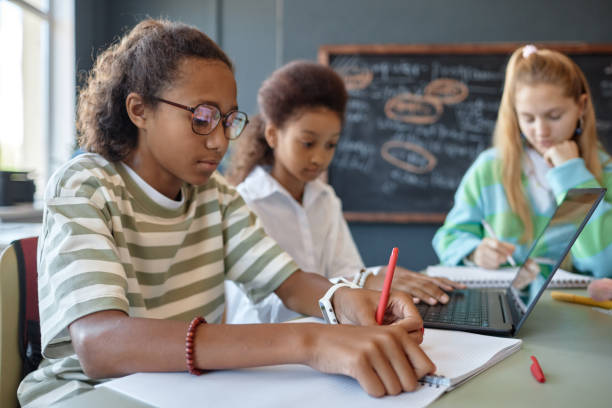 istock Black Teen Boy Wearing Glasses Studying in Class 2193187549