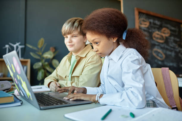 istock Black Girl Using Laptop in Class Working on Online Tasks 2193187559