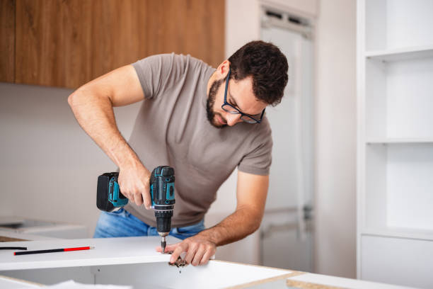 istock Caucasian Kitchen Fitter Installing Cabinets in New Apartment 2193187674