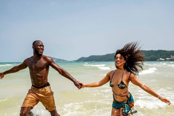 istock Joyful Couple Running on a Sunny Beach Day 2193188776
