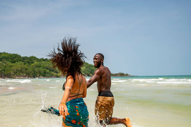 istock Couple Joyfully Playing in the Ocean Waves on a Sunny Day 2193188787