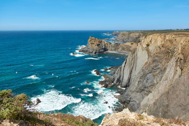 istock Stunning sheer and steep cliffs above the Atlantic Ocean in Arrifana 2193189786