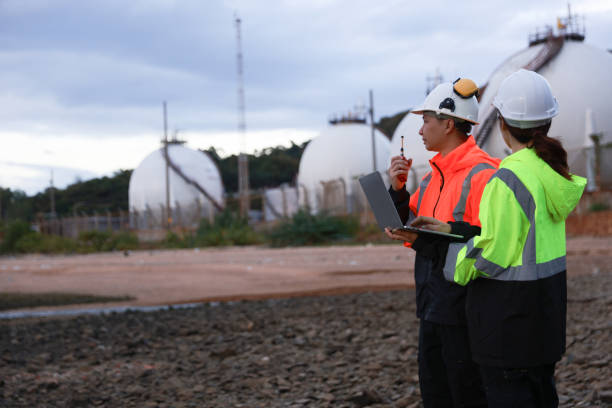 istock Blue-collar workers work at the oil storage field industrial site. Engineering and industrial concept. 2193192528