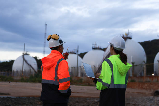 istock Blue-collar workers work at the oil storage field industrial site. Engineering and industrial concept. 2193192537