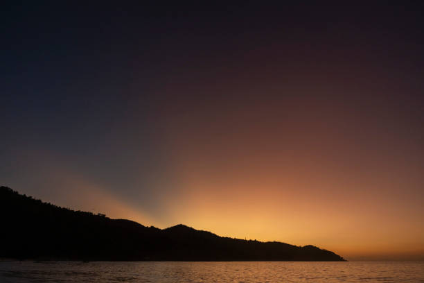 istock View across tranquil bay to sunset and island 2193194815