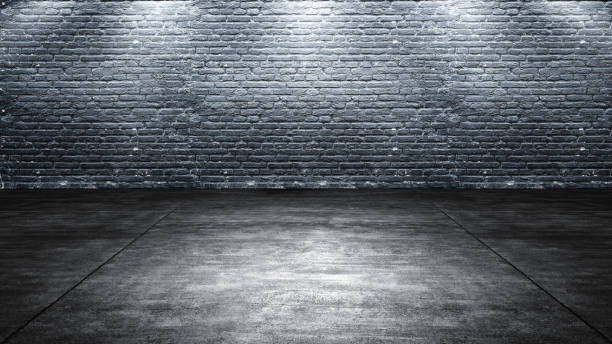 istock Black wall with plastered concrete floor. Abstract pattern of a brick wall 2193195999