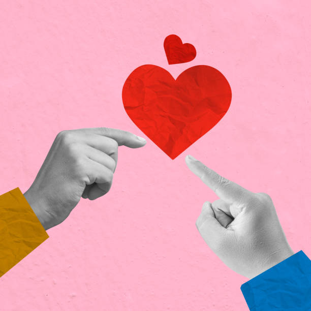 istock A human hand pointing to a red heart on a colored background 2193196951