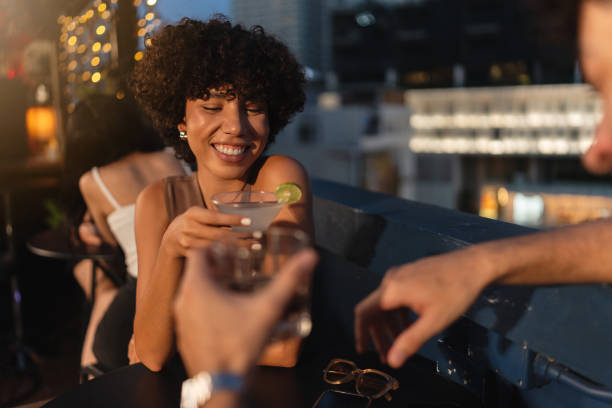 istock Young couple enjoying drinks at a rooftop bar 2193197022