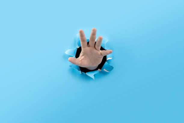 istock Human hand showing his palm from ripped paper 2193197281