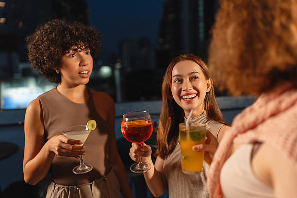 istock Women chatting with drinks at a rooftop bar 2193198089