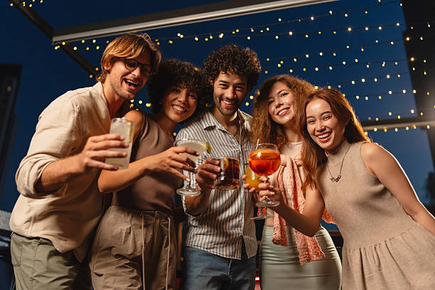 istock Friends enjoying cocktails on a rooftop 2193198112