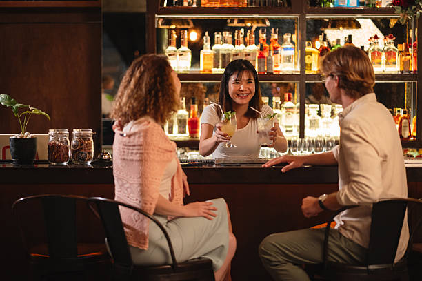 istock Young couple enjoying drinks at a bar 2193199100