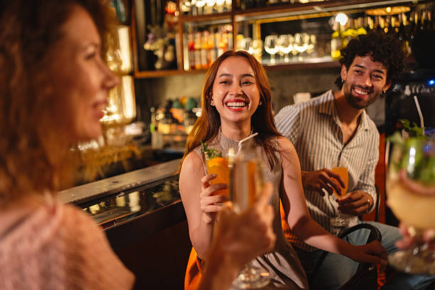 istock Friends enjoying cocktails at the bar 2193199234