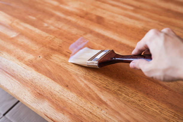 istock Apply clear wood stain on wooden table with brush 2193202245