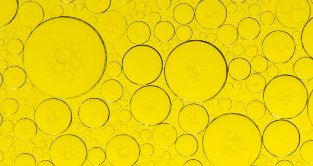 istock Macro microscope yellow bubble texture, Close-up Yellow bubbles and drops oil background . golden Yellow water bubbles, close up golden oil drop for celebration 2193202355