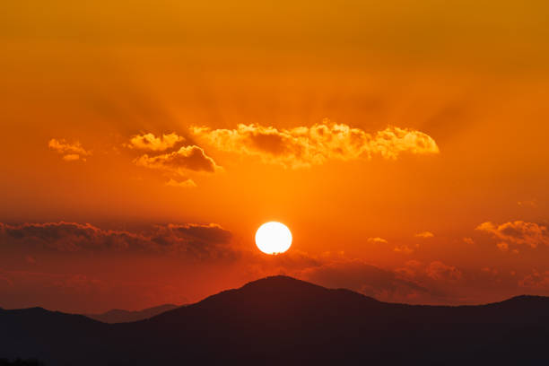 At dusk, the sun sets over the mountains.