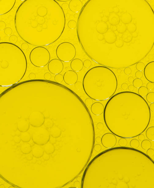 istock Macro microscope yellow bubble texture, Close-up Yellow bubbles and drops oil background . golden Yellow water bubbles, close up golden oil drop for celebration 2193202661