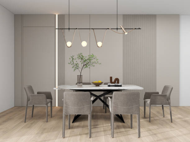 istock A modern dining room with minimalist decor featuring a marble table, gray upholstered chairs, a unique pendant light, and a vase with green branches. 2193202688