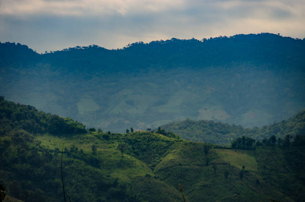 istock Mountains hills with many agriculture fields surrounded by nature with cloudy sky 2193203359