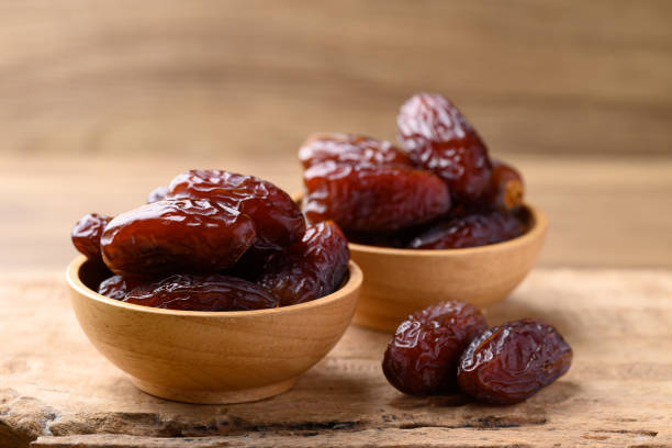 istock Date palm fruit (MedJool) in wooden bowl 2193204783