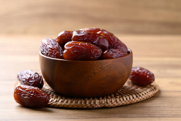 istock Date palm fruit (MedJool) in wooden bowl 2193204819