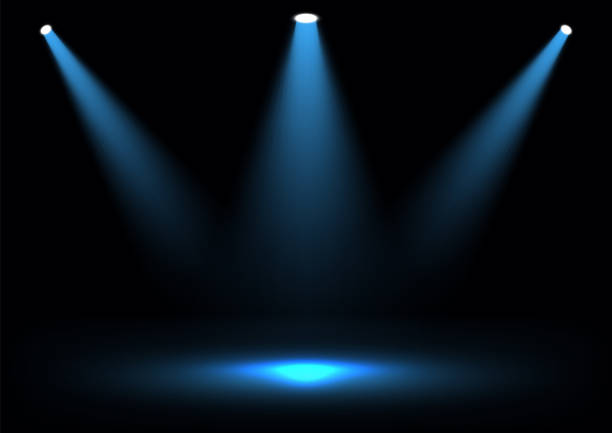 istock Dramatic blue spotlights converge on a dark stage creating a bold focal point for product displays, performances, or creative lighting projects. 2193206284
