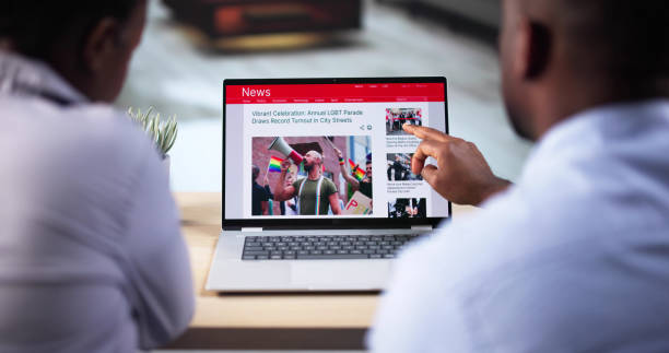 istock Watching Online News Article On Mobile Phone And Laptop 2193206871