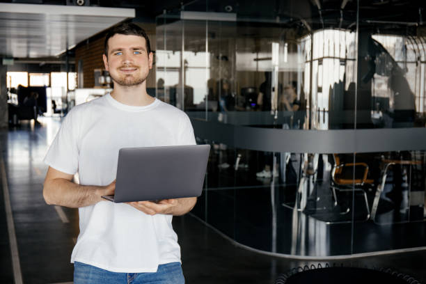 istock A cheerful young entrepreneur works in a modern workspace 2193207091
