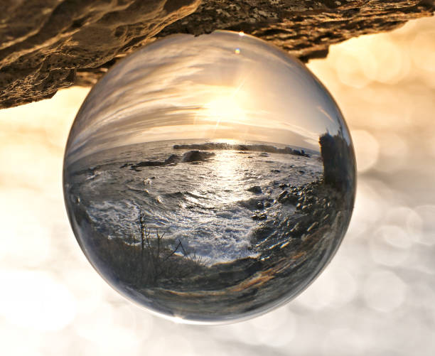 istock Morning reflections over the ocean at sunrise looking through a crystal ball. 2193207118