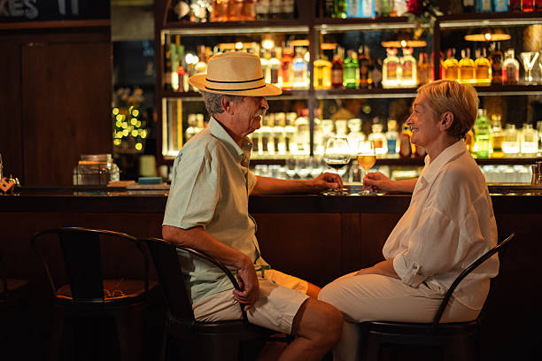 istock Senior couple enjoying drinks and conversation at the bar 2193207927
