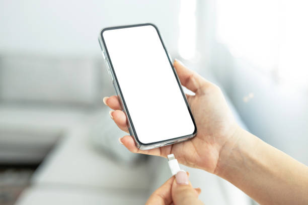 istock Hand charging mock up screen phone with usb cable at home 2193208767