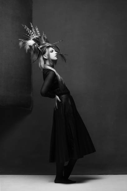 istock Woman with feather headpiece studio portrait 2193210820