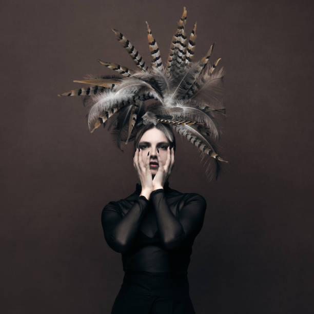 istock Woman with feather headpiece sensual studio portrait 2193210821