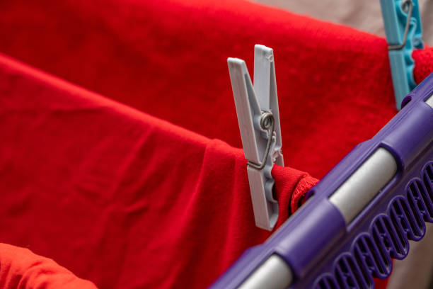 Laundry hanging with clothespins on a clothesline inside the house