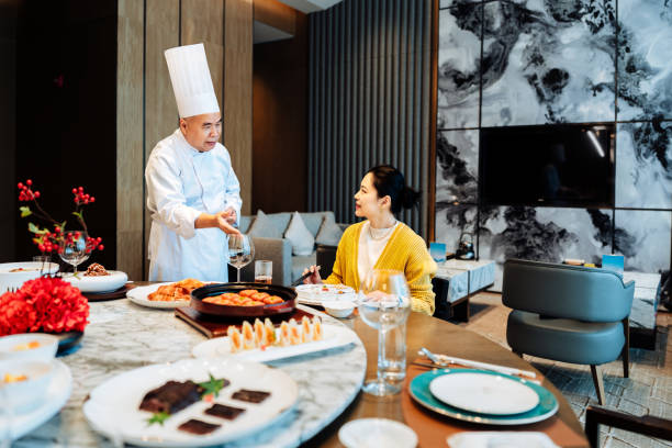 istock Asian senior chef introducing his new dish to the distinguished guest. 2193214264