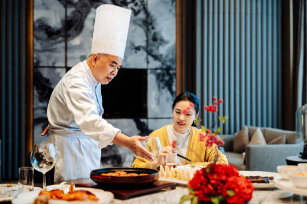 istock Asian senior chef introducing his new dish to the distinguished guest. 2193214270