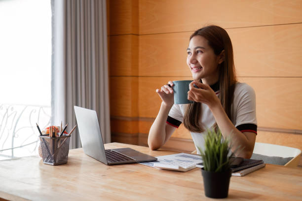 istock Young Woman in Modern Room Focused on Paperwork and Organizing Documents for Business or Study 2193214455