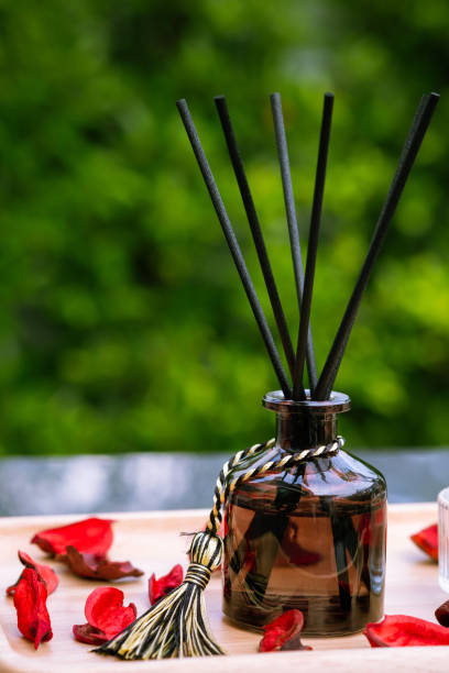 istock Closeup to a black bottle of aroma reed diffuser with green nature background 2193214572