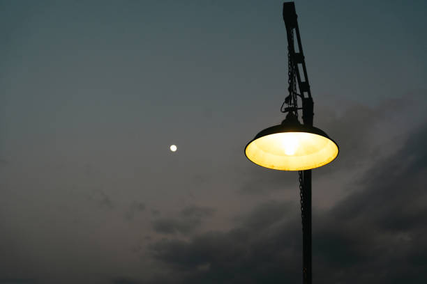 istock Electric lamp on retro style against moon and night sky 2193215540