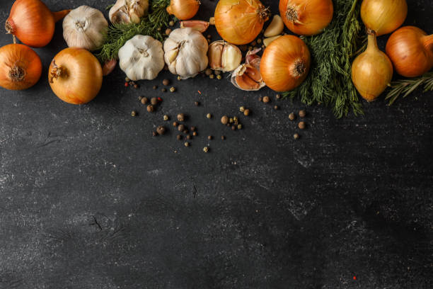 istock Fresh onions, garlic, dill, and peppercorns arranged on a dark rustic background. Perfect for culinary concepts, food styling, or showcasing organic ingredients 2193216522